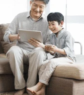 Grandparent and grandchild sharing a tablet